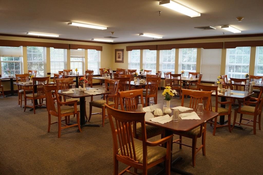 An indoor dining area with neatly arranged tables and chairs, featuring a cozy atmosphere.