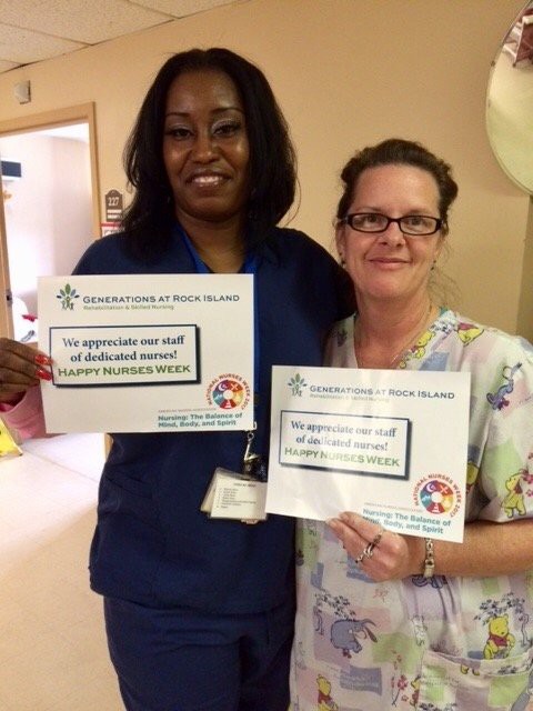 Two nurses holding appreciation certificates at a healthcare facility.