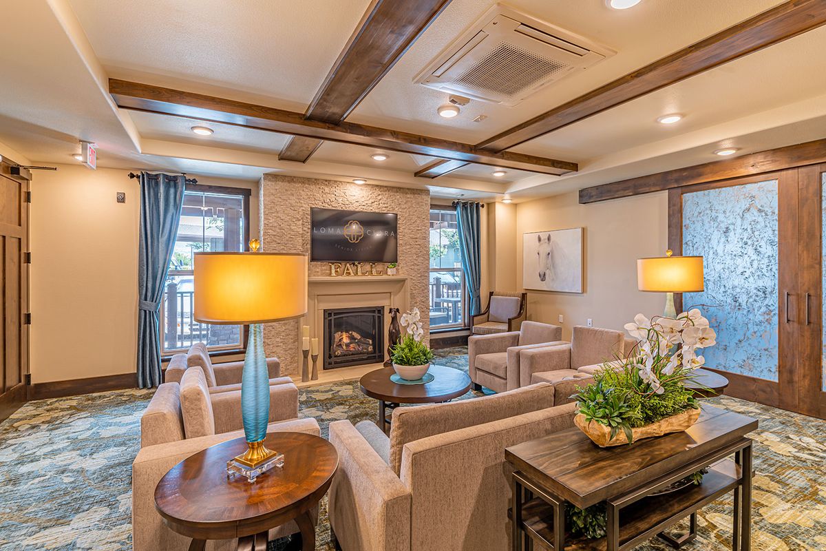 A cozy and modern living room featuring a fireplace, stylish furniture, and elegant lighting.
