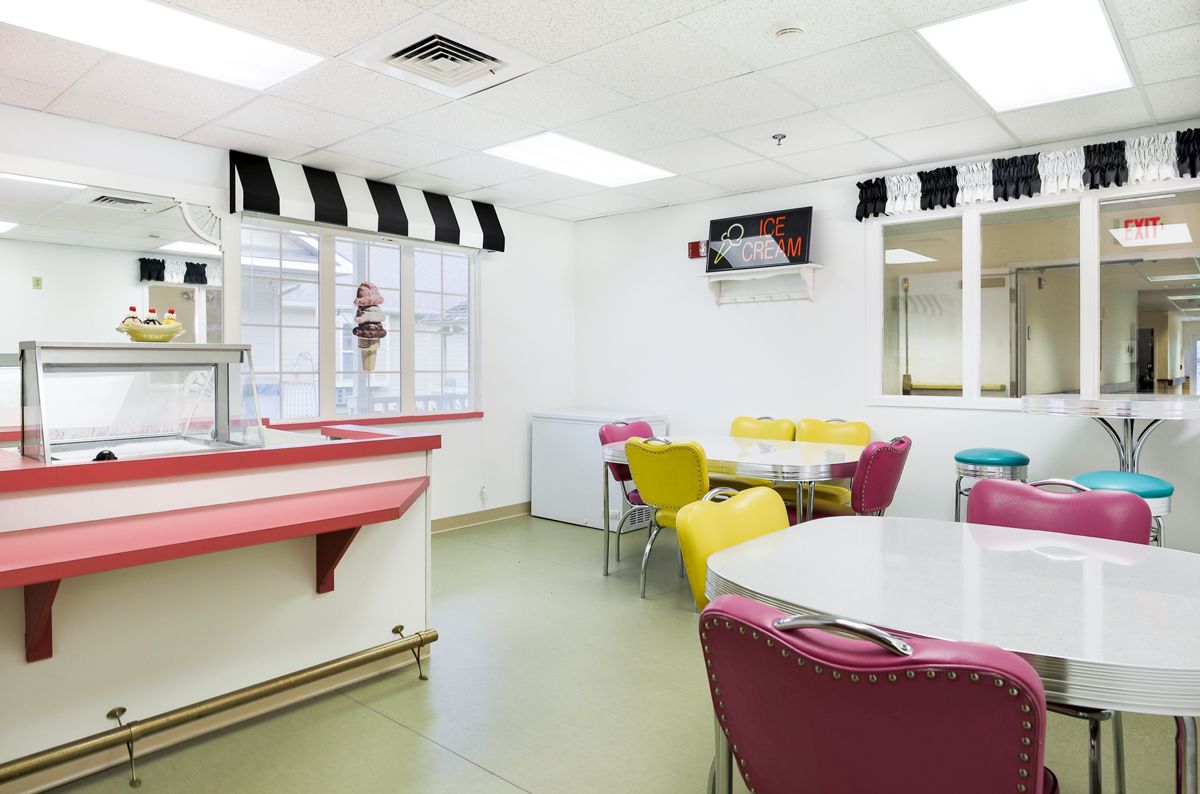 A retro-style diner interior with colorful chairs and tables.