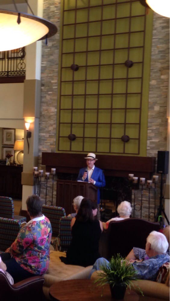 A person giving a presentation to an audience in an indoor setting.