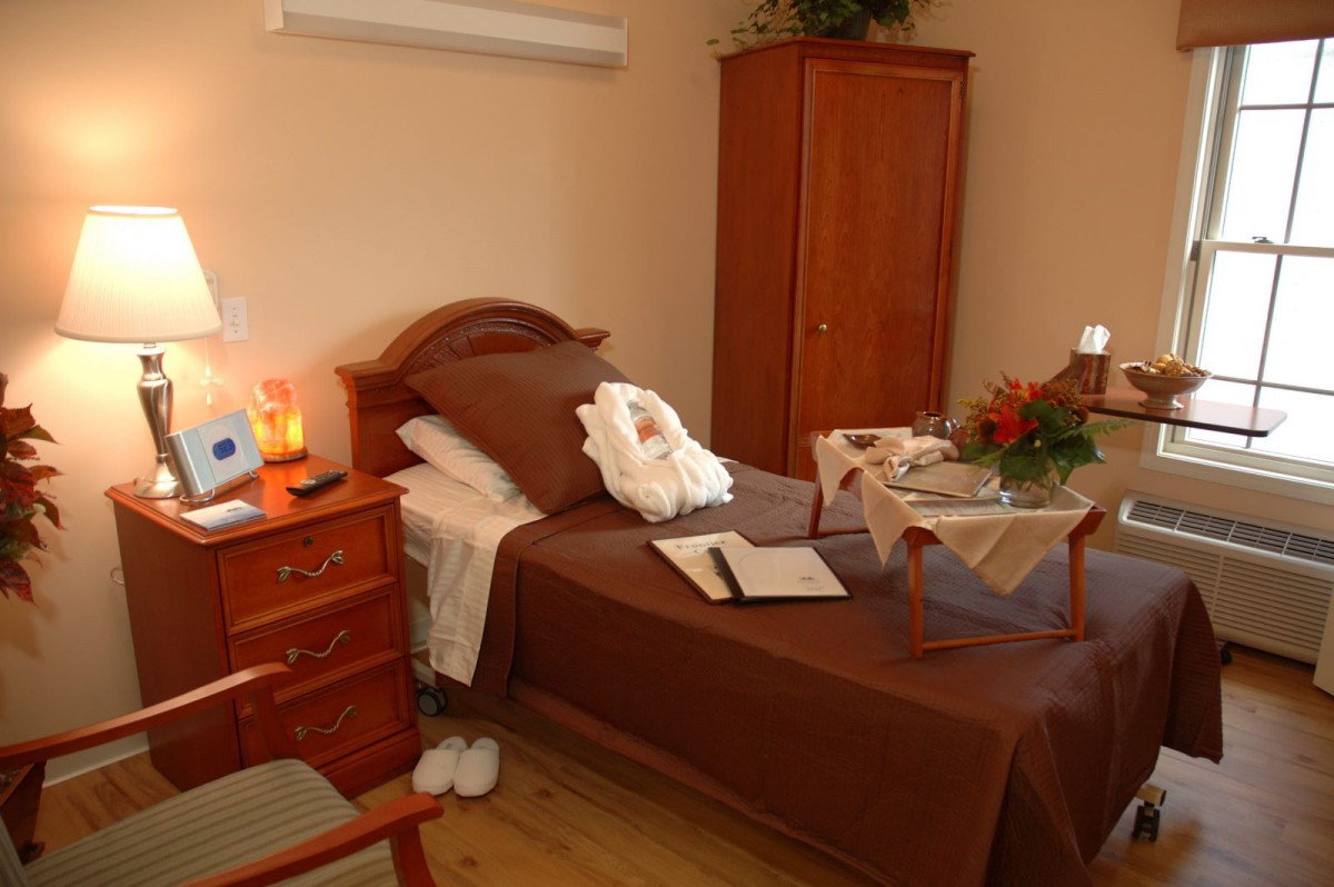 A cozy, small bedroom with a single bed and warm decor.