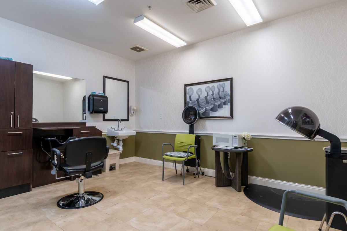A modern hair salon interior with chairs, mirrors, and styling equipment.