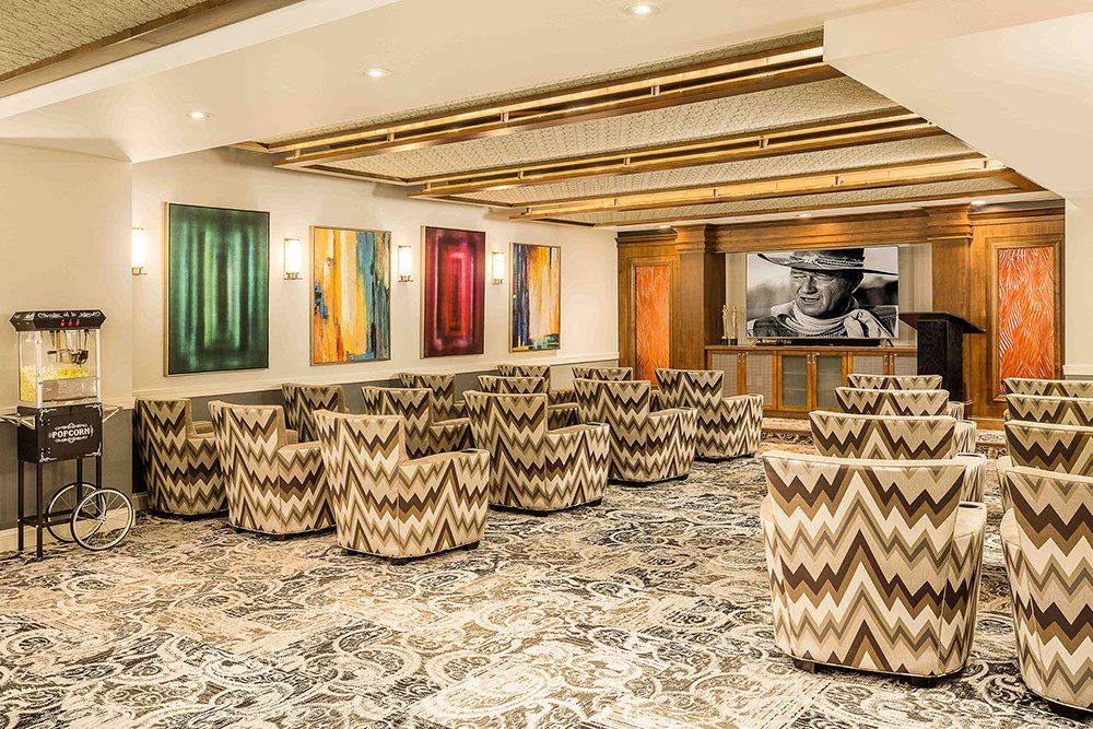 Modern lounge area with patterned chairs and vibrant artwork.