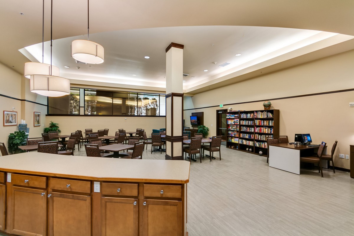 A modern library interior with tables and bookshelves.