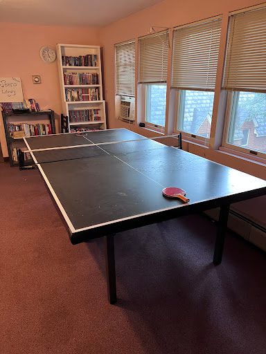 A spacious ping pong table set up indoors, ready for a game.