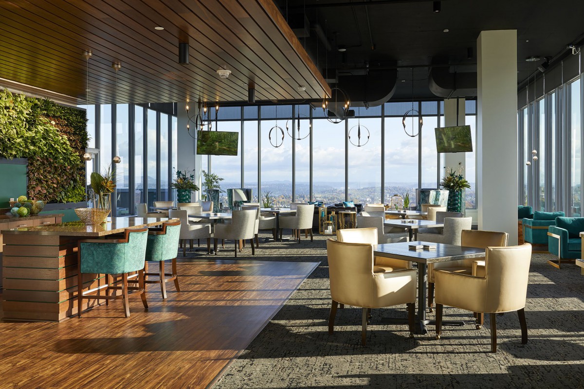 A modern restaurant interior with large windows offering a scenic view.