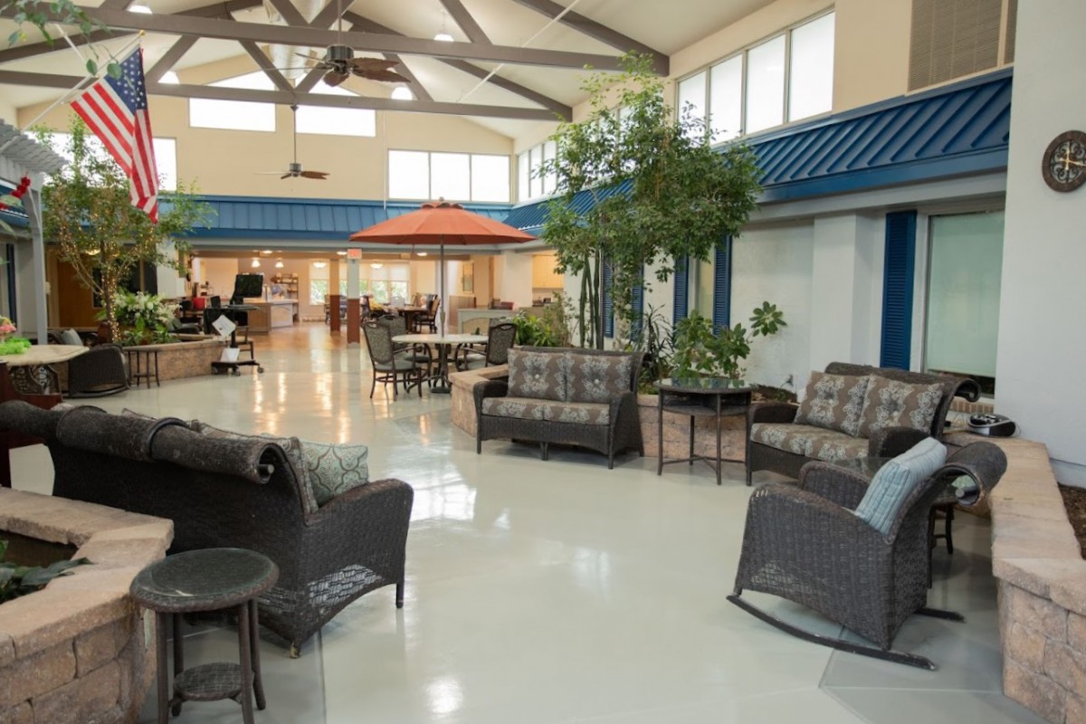 A spacious lobby area with comfortable seating and indoor plants.