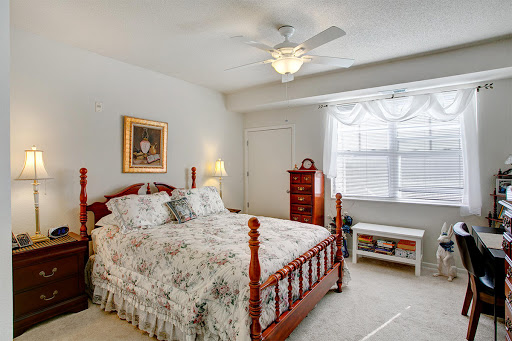 A cozy and well-decorated bedroom featuring a comfortable bed, elegant furnishings, and natural light.