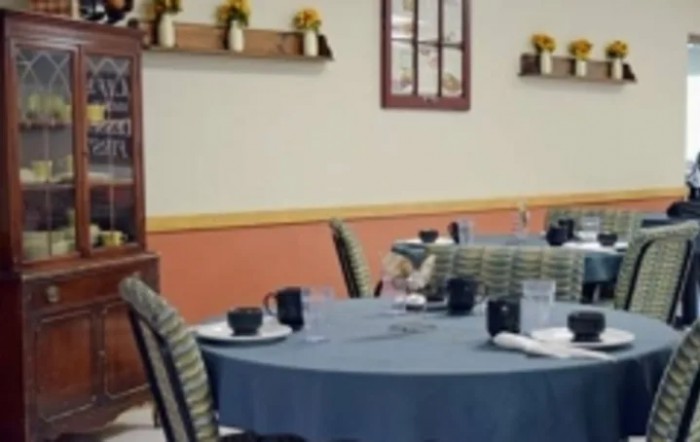 A neatly arranged restaurant dining area with tables set for guests.
