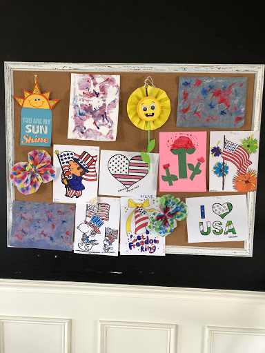 A vibrant bulletin board showcasing various children's art projects with patriotic themes.