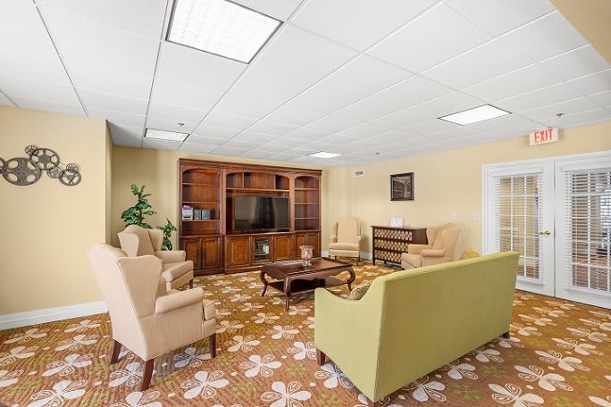 A cozy living room with comfortable seating and a TV cabinet.