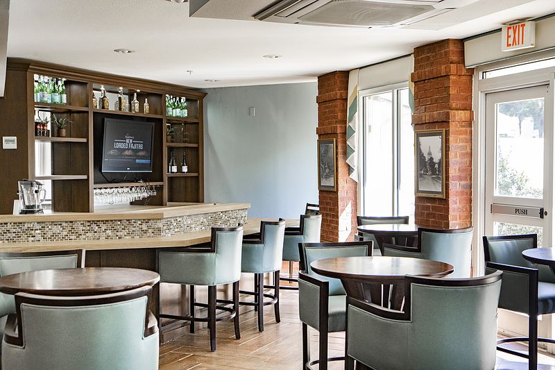 A modern bar interior with comfortable seating and a stylish counter area.