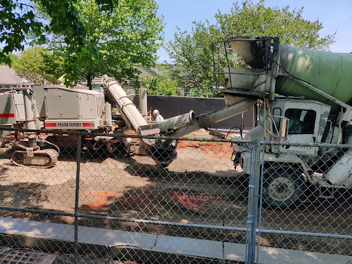 A concrete mixer and equipment working at a construction site.