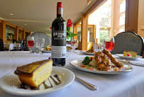 A beautifully set dining table with wine and delicious food.