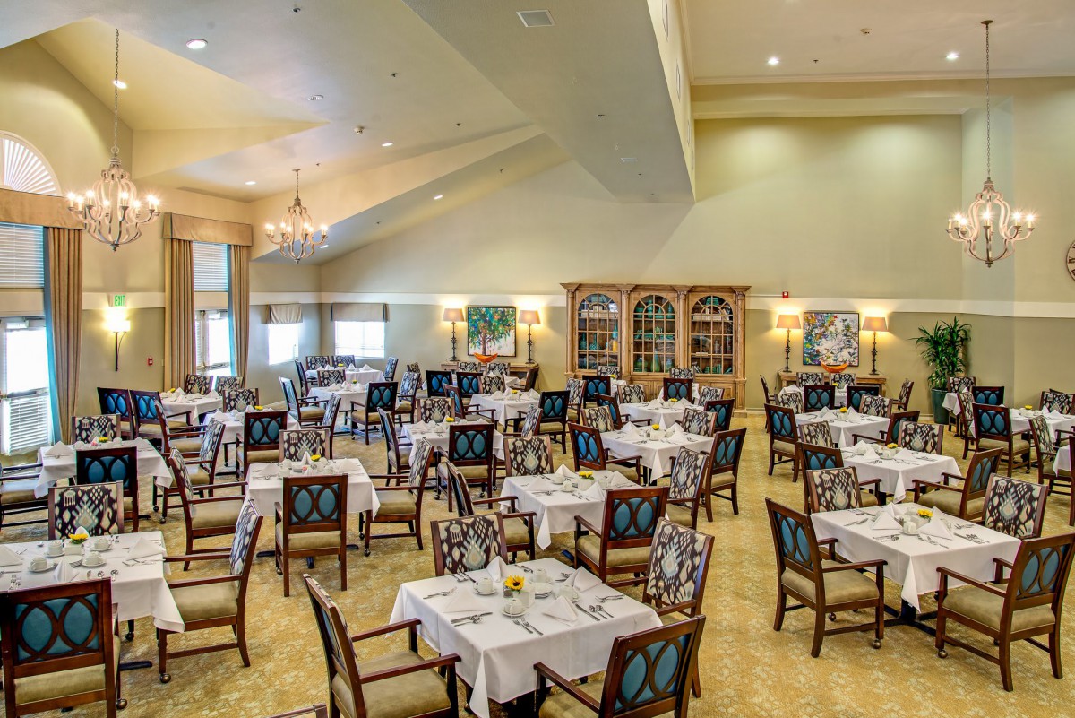 An elegant dining room with neatly arranged tables and chairs.