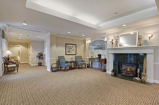 A spacious lobby area with a cozy fireplace and comfortable seating.