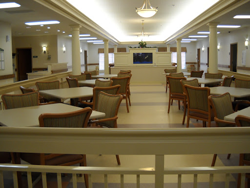 A spacious dining area with modern furniture, featuring bright lighting and a welcoming atmosphere.