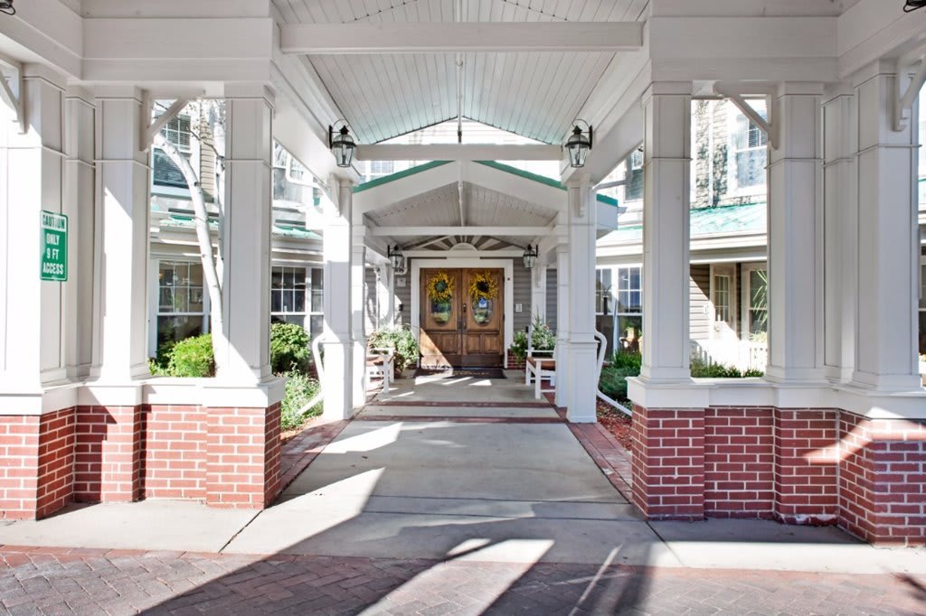 A welcoming building entrance with a covered walkway and columns.