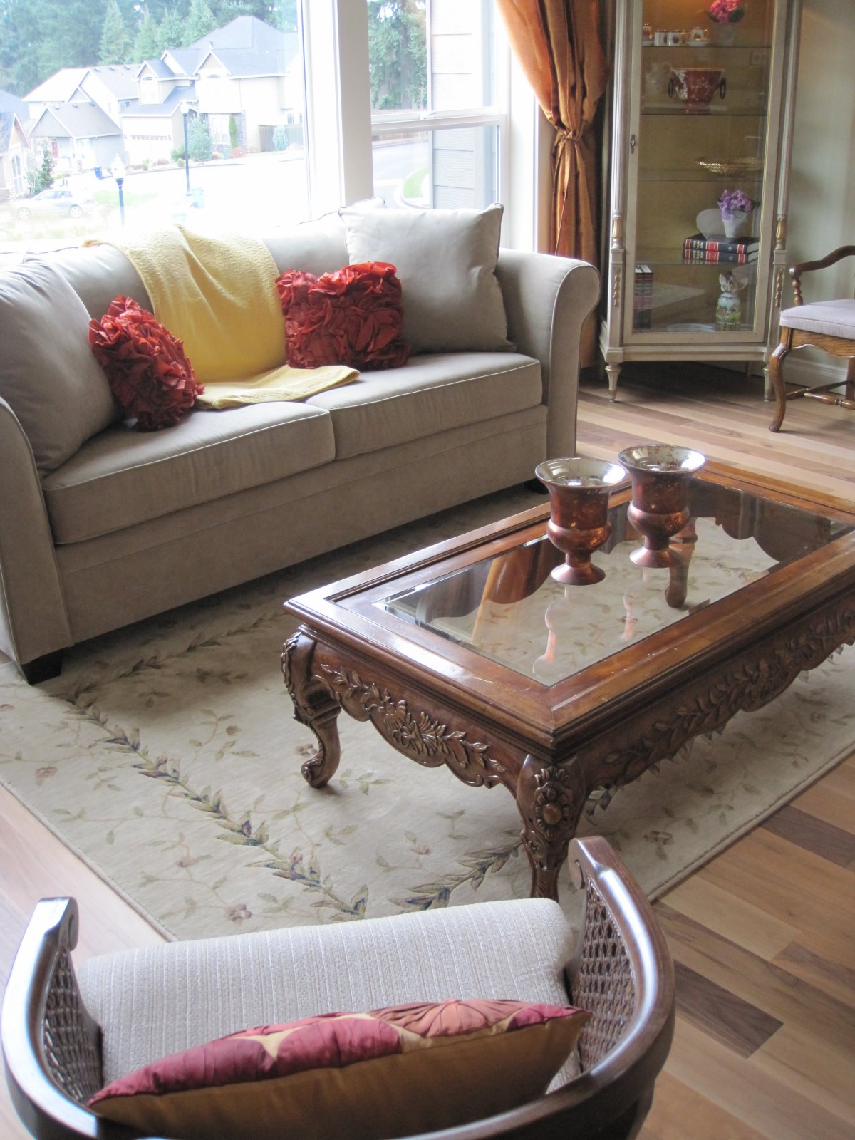 A cozy living room with a sofa, ornate coffee table, and decorative cushions.