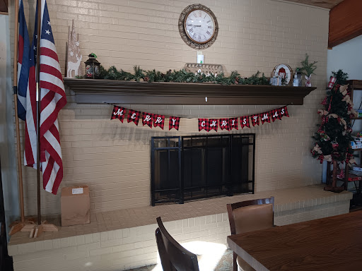 A cozy living room setting with festive Christmas decorations adorning the fireplace mantel.