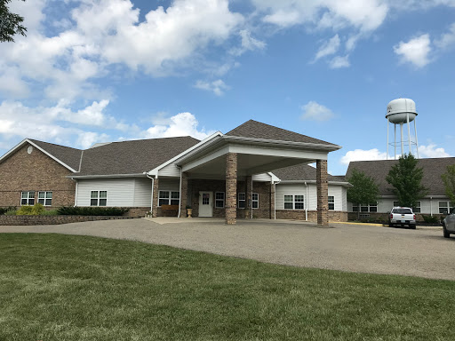 A modern healthcare facility with a welcoming entrance under a bright sky.