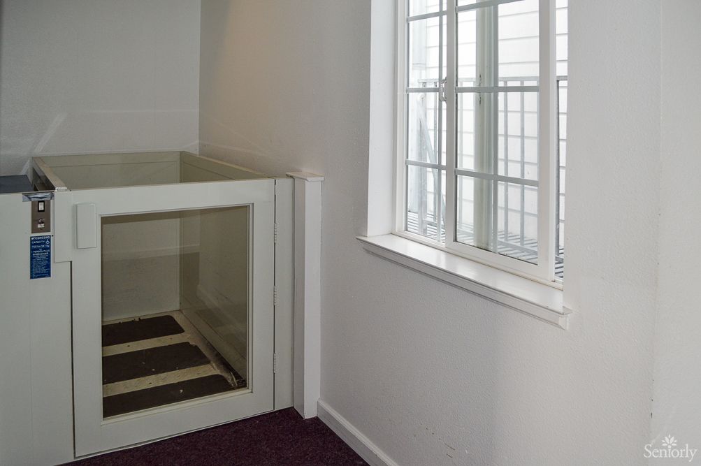 An interior space with an elevator and a window.
