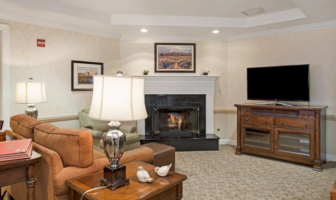 A cozy living room with a fireplace, comfortable seating, and tasteful decor.