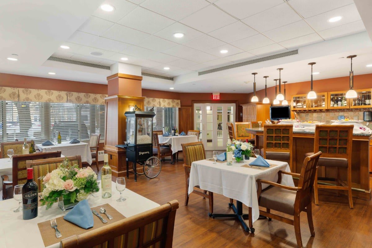 A cozy and elegantly decorated restaurant dining area with neatly arranged tables and chairs.