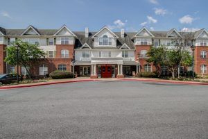 A large residential building with a symmetrical facade and entrance.