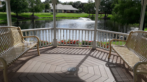 A serene view from a gazebo overlooking a peaceful pond.
