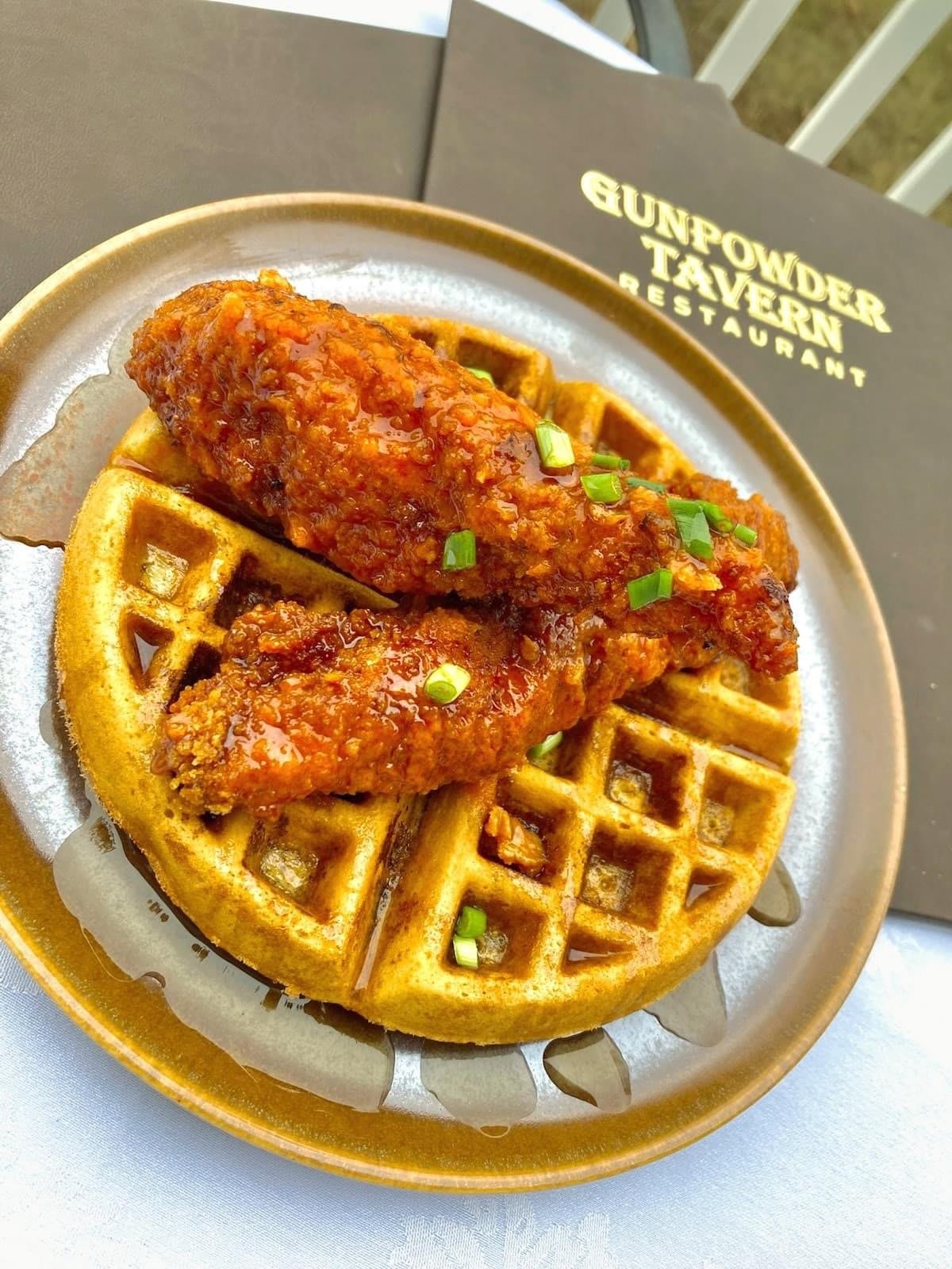 Delicious fried chicken served on crispy waffles at a restaurant.