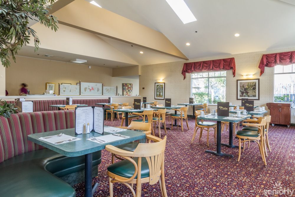 A cozy restaurant interior with neatly arranged tables and chairs.