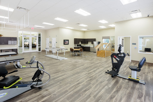 A spacious and modern fitness area equipped with various exercise machines.