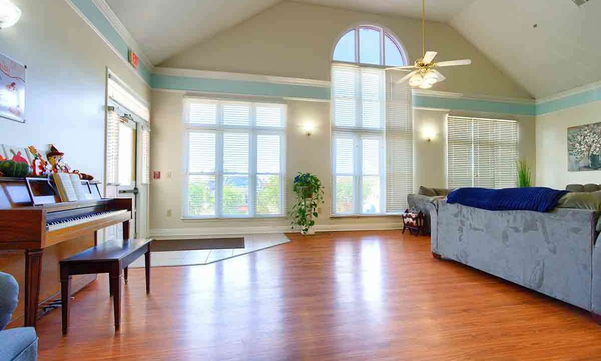 Spacious living room with high ceilings and large windows allowing natural light to flood the space.