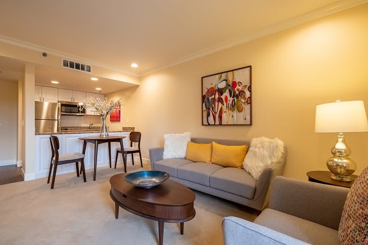 A modern and cozy living room with stylish furniture and artwork.