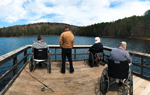 A group of individuals enjoying a peaceful day by the lake.