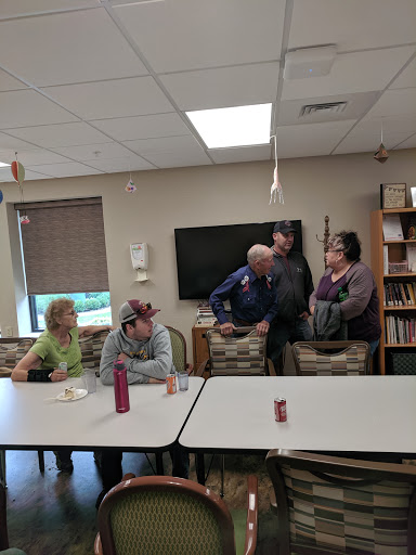 A group of people engaged in conversation in a community space.