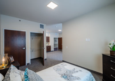 A minimalist bedroom featuring modern decor with an open door leading to an adjacent room.