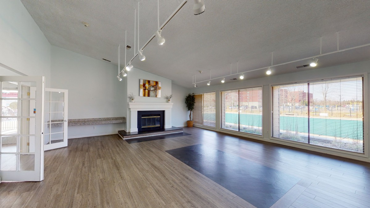 Spacious living room with large windows and modern lighting.