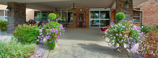 A welcoming entrance adorned with colorful flowers and lush greenery.