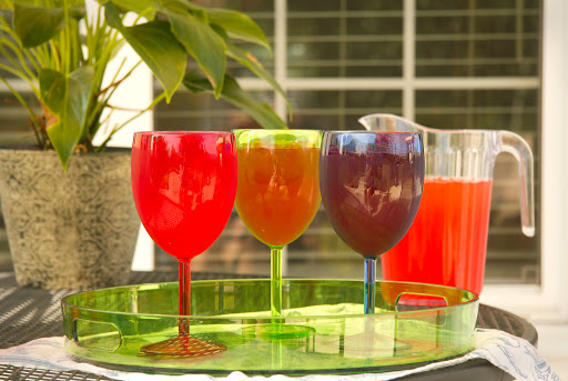 A vibrant display of colorful drinks on a sunny day.