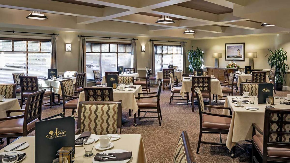 An elegant dining area with neatly arranged tables and chairs, featuring soft lighting and tasteful decor.