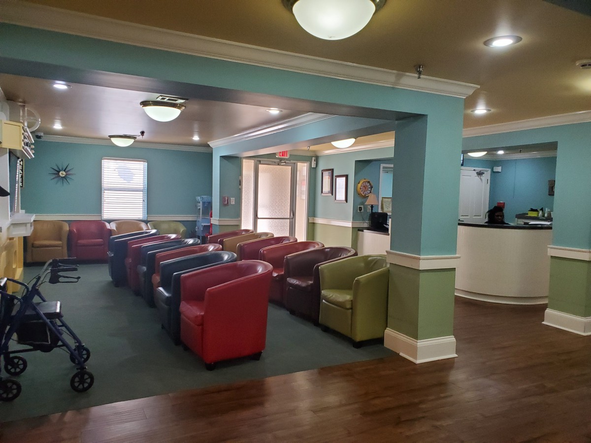 A spacious lobby with colorful chairs and bright lighting.