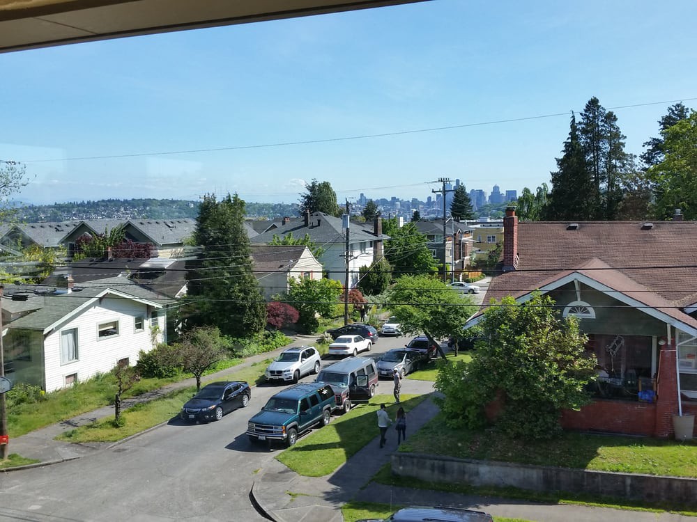 A suburban neighborhood with a view of the city skyline in the distance.