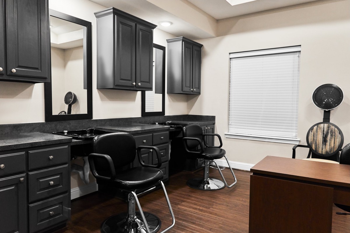 A modern hair salon interior with styling chairs and mirrors.