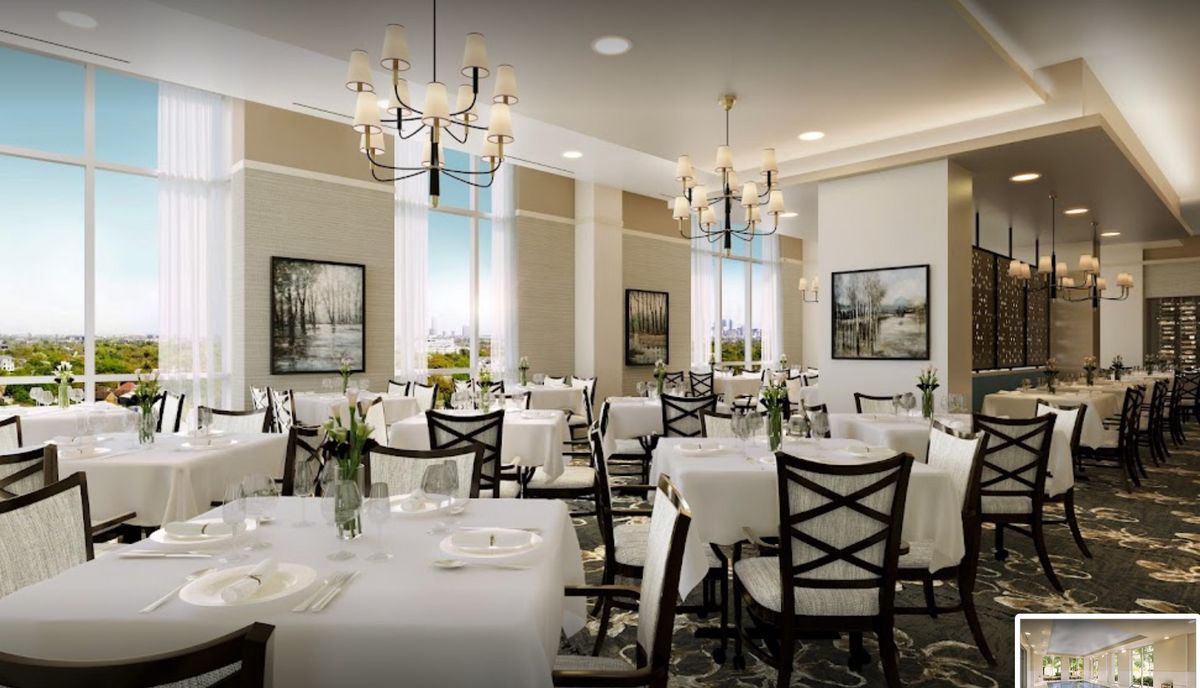 A sophisticated dining room setup with elegantly arranged tables and chandeliers.