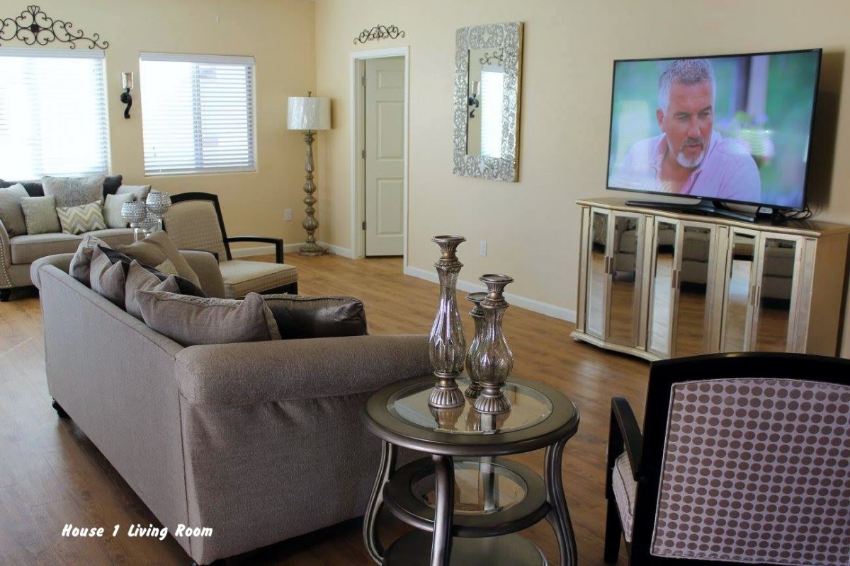 A cozy living room with modern decor and a large TV.
