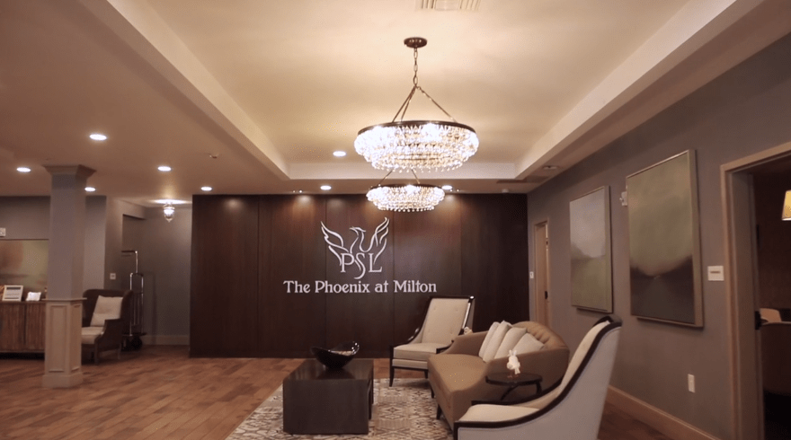 A stylish lobby with elegant chandeliers and comfortable seating at The Phoenix at Milton.
