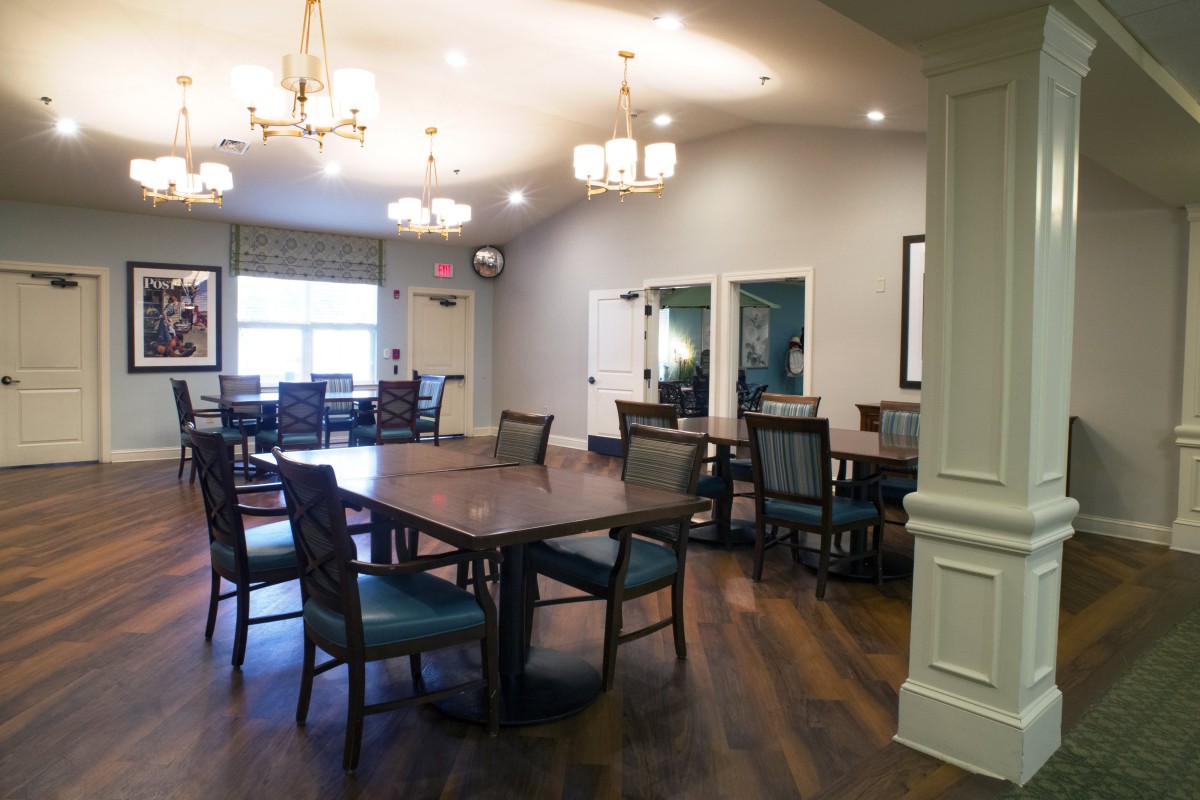 Elegant dining area with wooden floors and modern lighting.